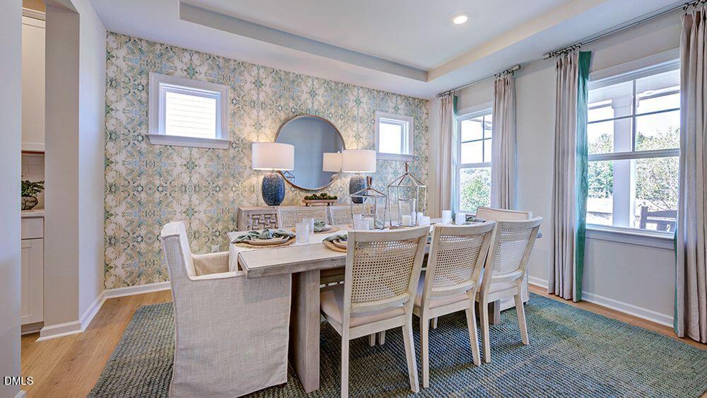 151 Rivulet Court Cary, NC 27519 - Photo 9 of 37 a dining room with furniture a window and a wooden floor