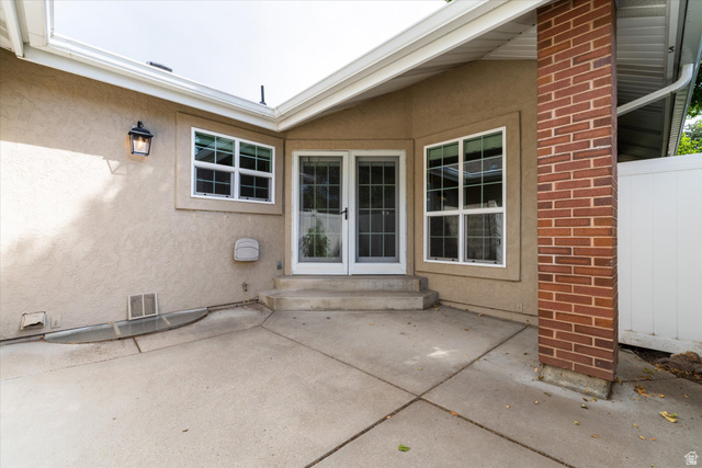 888 East 6895 South Midvale, UT 84047 - Photo 43 of 54 Enclosed patio space with concrete surface and surrounding privacy fencing, ideal for outdoor seating, dining, or low-maintenance enjoyment.