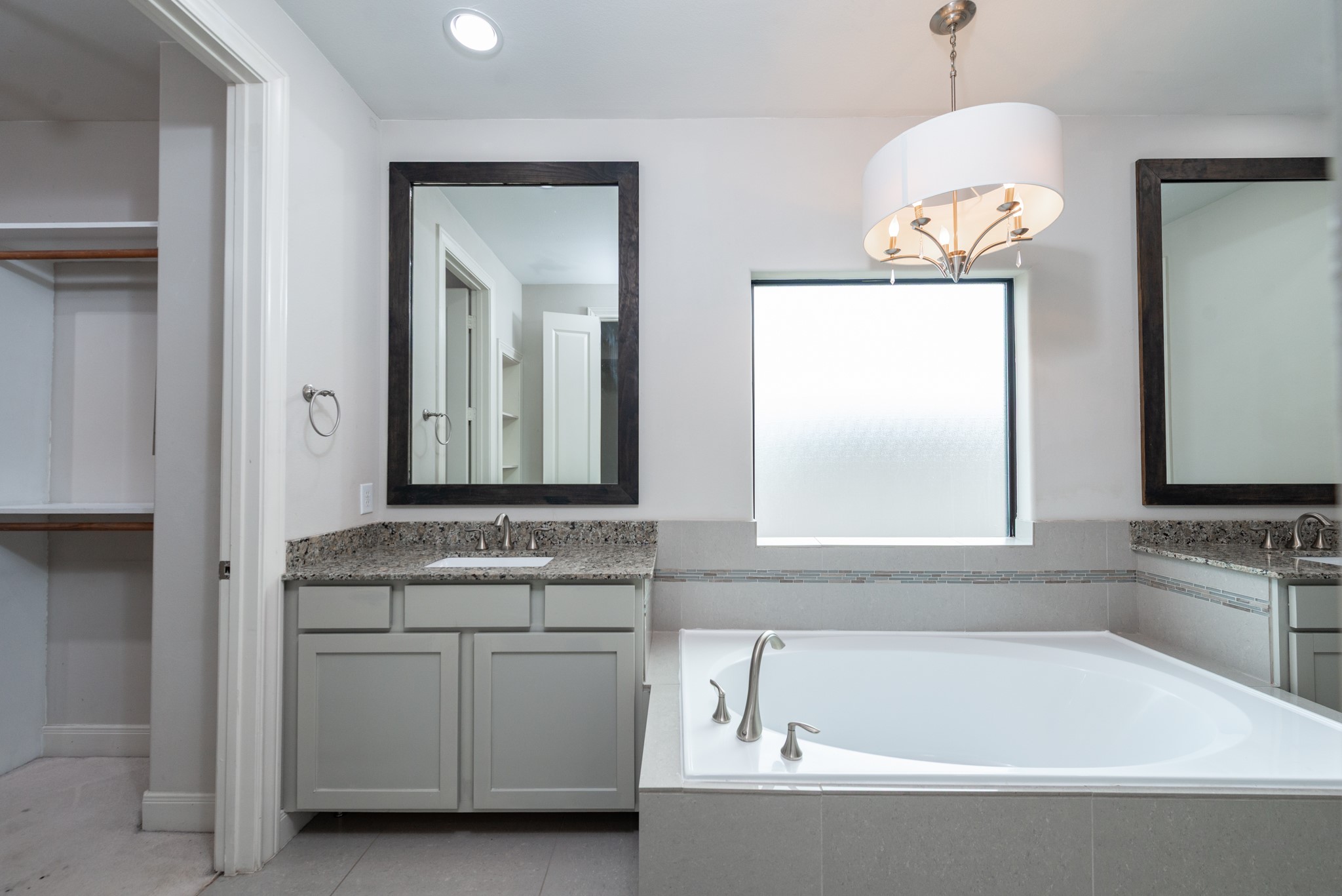 3504 Chenevert Street, Unit A Houston, TX 77004 - Photo 16 of 33 a bathroom with a bathtub a sink and a window