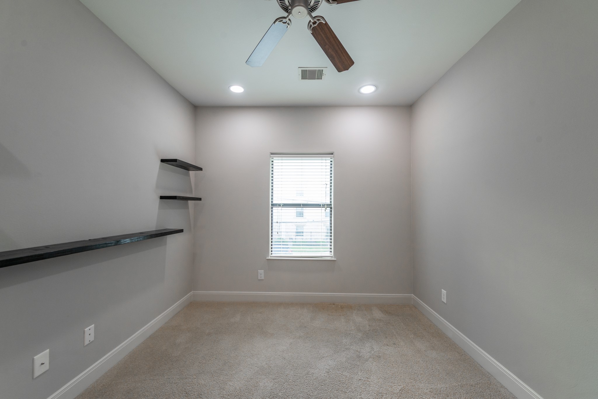 3504 Chenevert Street, Unit A Houston, TX 77004 - Photo 28 of 33 an empty room with a window and ceiling fan