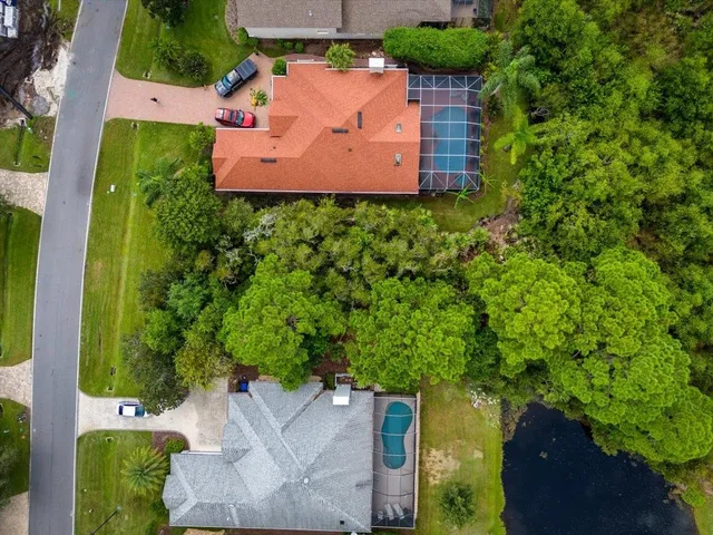 an aerial view of a house with garden space and street view