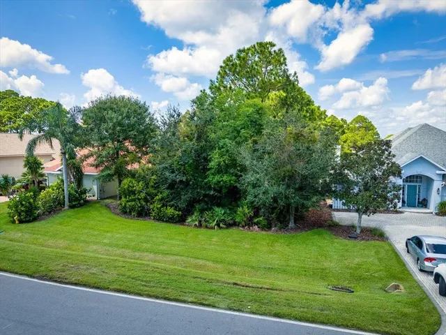 a view of a backyard with a garden and entertaining space