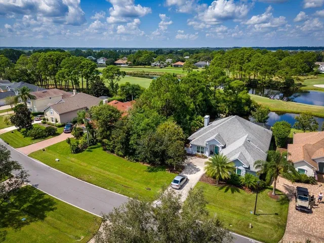 an aerial view of a house with a garden and a yard