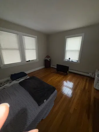 wooden floor in an empty room with a window