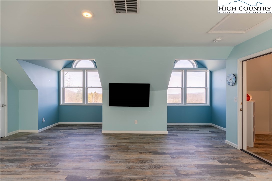 449 Meadow Ridge Drive Jefferson, NC 28640 - Photo 21 of 37 a view of an empty room with window and wooden floor