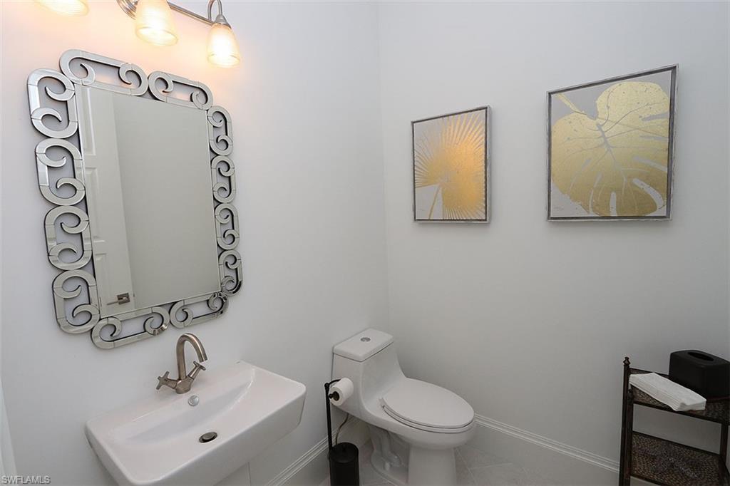 300 2nd Avenue North Naples, FL 34102 - Photo 13 of 41 a bathroom with a toilet sink and mirror