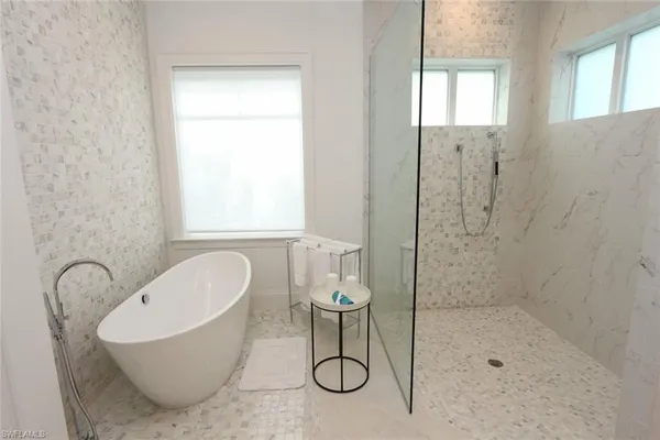 a bathroom with a bathtub and shower