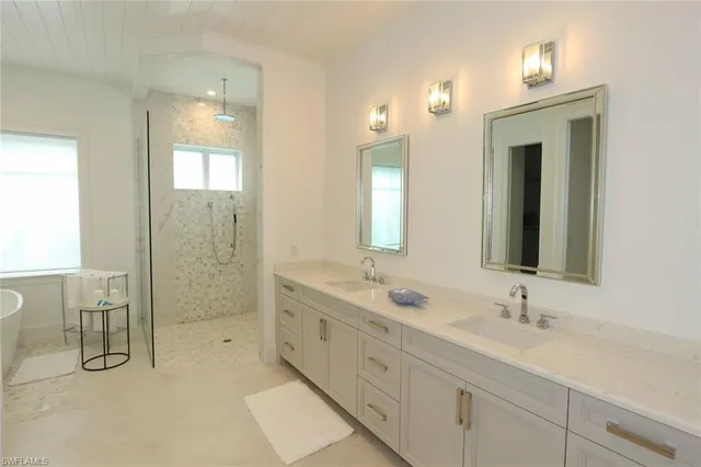 a bathroom with double sink and a mirror
