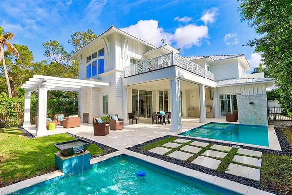 a view of a house with pool table and chairs
