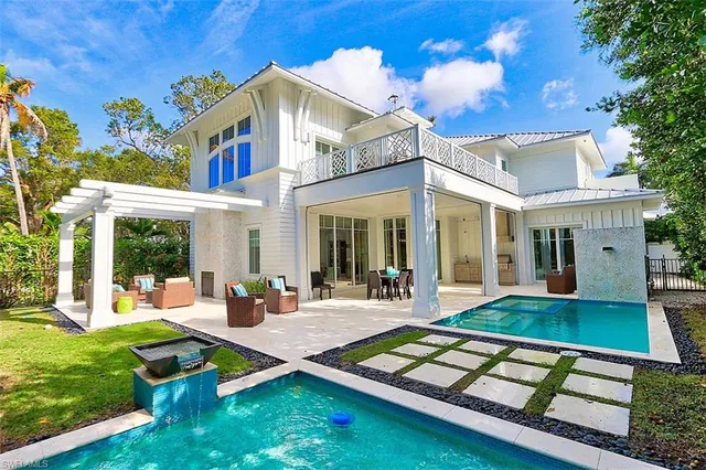 a view of a house with pool table and chairs
