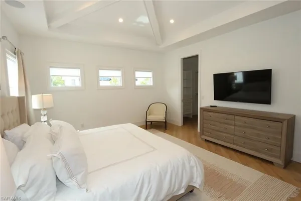 a bedroom with a bed and a flat screen tv