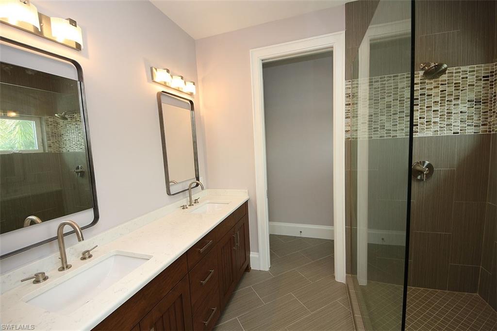 300 2nd Avenue North Naples, FL 34102 - Photo 25 of 41 a bathroom with a double vanity sink mirror and shower