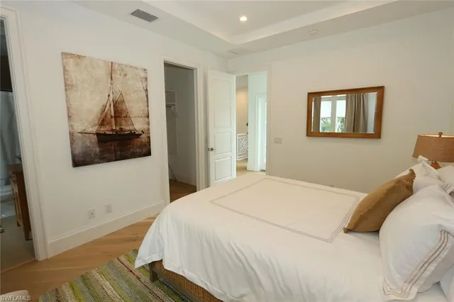a bedroom with a bed and a painting on the wall