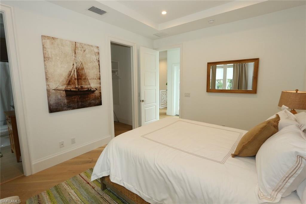 300 2nd Avenue North Naples, FL 34102 - Photo 27 of 41 a bedroom with a bed and a painting on the wall