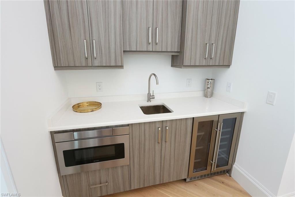 300 2nd Avenue North Naples, FL 34102 - Photo 34 of 41 a kitchen with a sink and cabinets