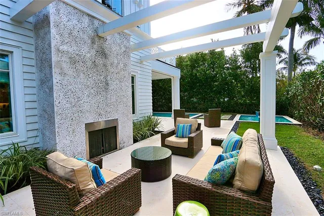a view of a patio with couches chairs and a yard