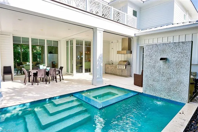 a view of a patio with table and chairs with wooden floor and garden