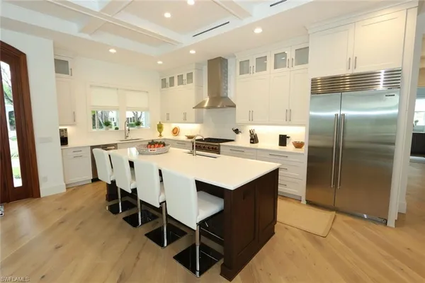 a kitchen with kitchen island a appliances dining table and chairs