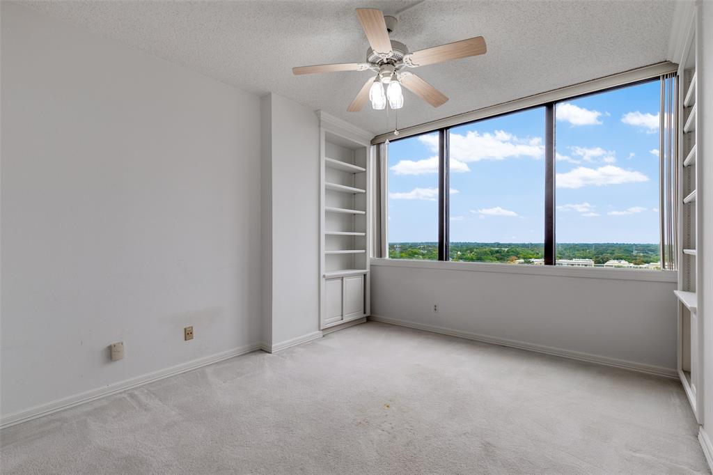 5200 Keller Springs Road, Unit 824 Dallas, TX 75248 - Photo 7 of 26 an empty room with large windows and city view