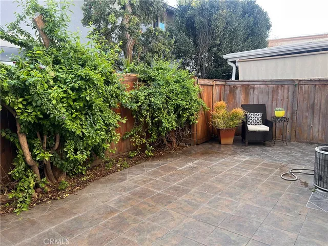 a view of a patio with table and chairs and potted plants