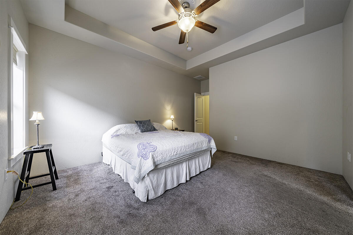 1078 North Haskell Street Central Point, OR 97502 - Photo 12 of 25 a bedroom with a bed and a chandelier