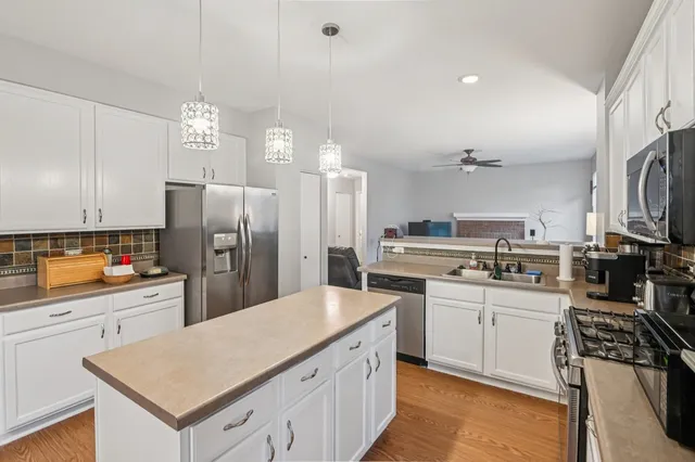 a kitchen with stainless steel appliances a sink cabinets and refrigerator