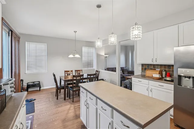 a kitchen with a table chairs sink and cabinets
