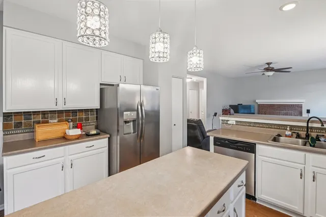 a kitchen with a refrigerator a stove and cabinets