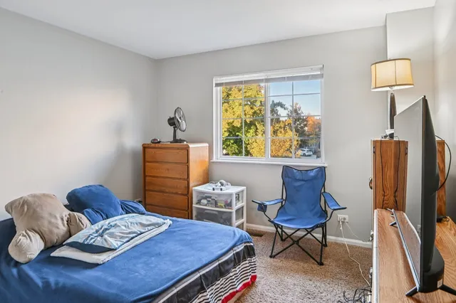 a bedroom with furniture and a window