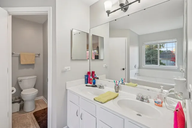 a bathroom with a sink vanity and a mirror