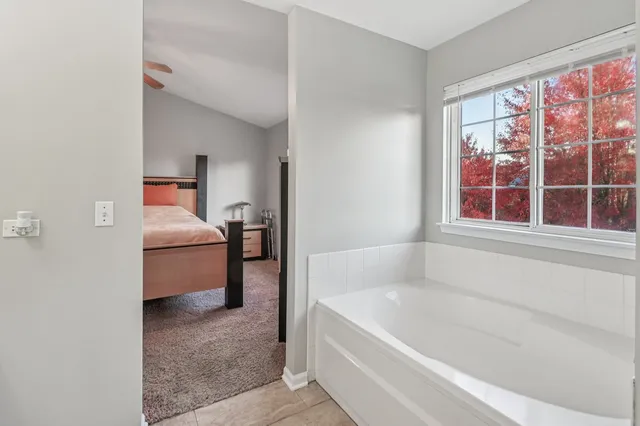 a bathroom with a bathtub and a window
