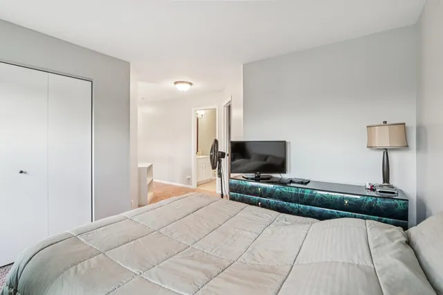 a bedroom with a bed and a flat screen tv