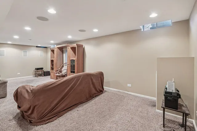 a spacious bedroom with a bed and a lamp