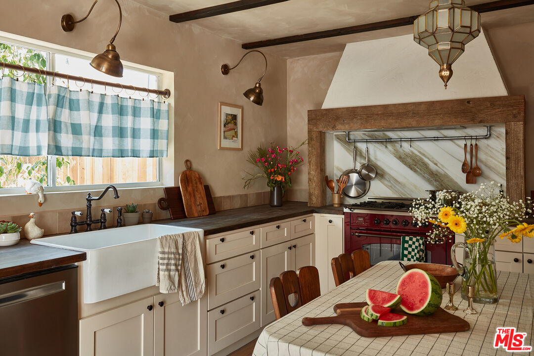 a kitchen with a sink appliances and cabinets