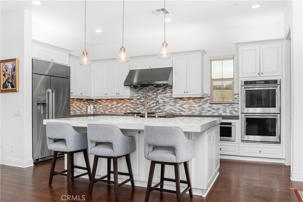 118 Ritual Irvine, CA 92618 - Photo 5 of 52 Double ovens, built-in fridge and added pendant lighting.