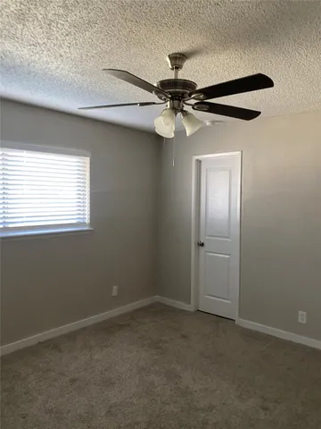 an empty room with a fan