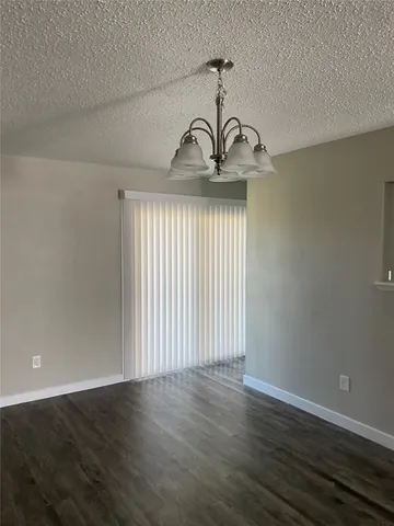a view of a livingroom with wooden floor and a window