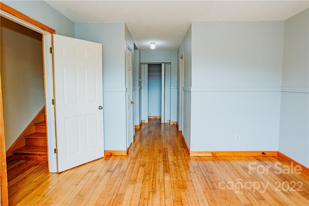 300 Boyd Road Leicester, NC 28748 - Photo 15 of 46 a view of a room with wooden floor and stairs