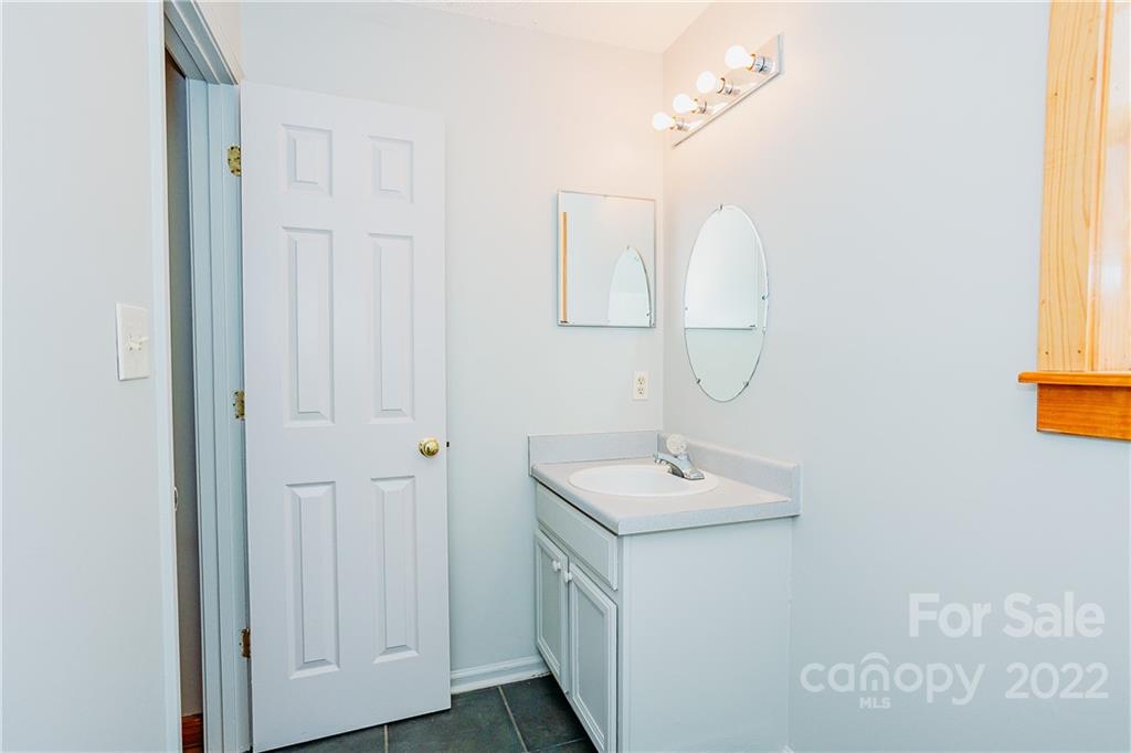 300 Boyd Road Leicester, NC 28748 - Photo 18 of 46 a bathroom with a sink a mirror and a window