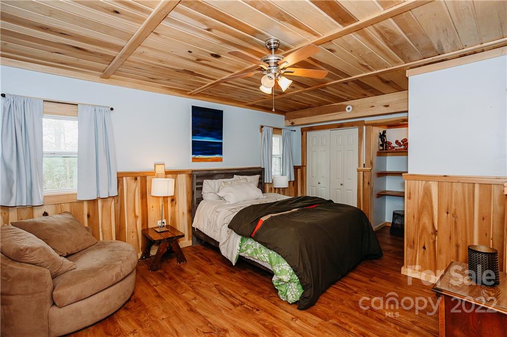 300 Boyd Road Leicester, NC 28748 - Photo 40 of 46 a bedroom with a bed couch and a ceiling fan