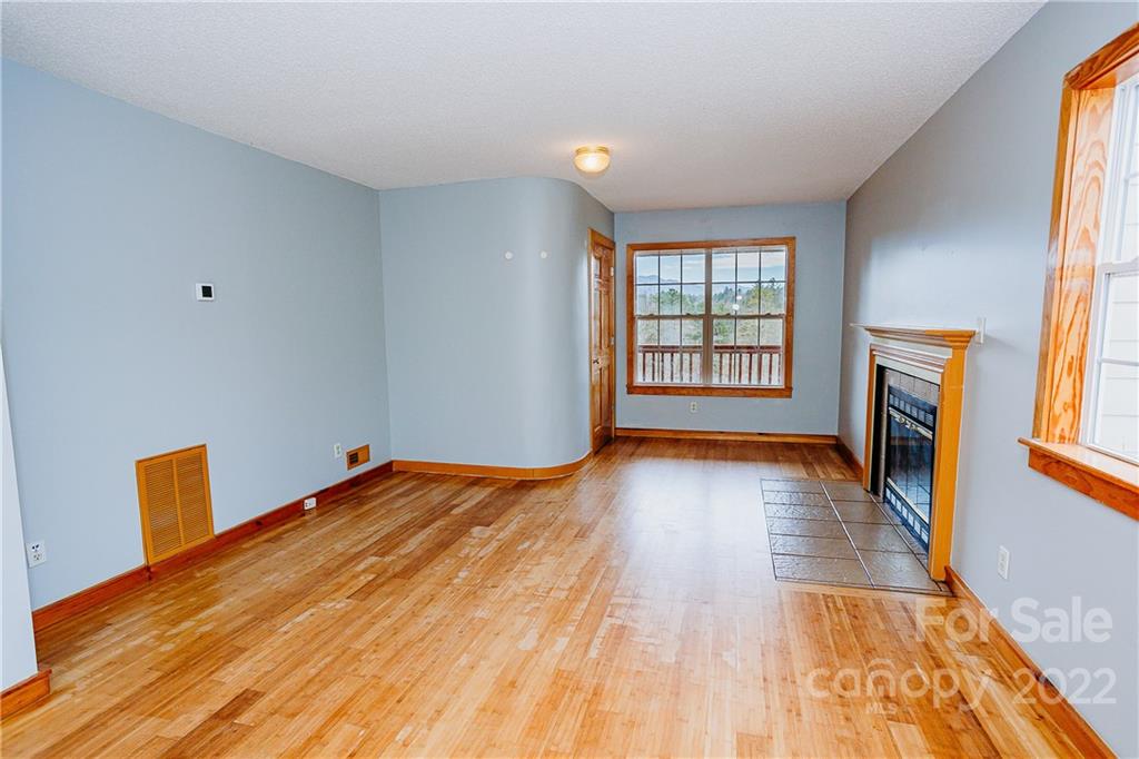 300 Boyd Road Leicester, NC 28748 - Photo 6 of 46 a view of an empty room with window and wooden floor