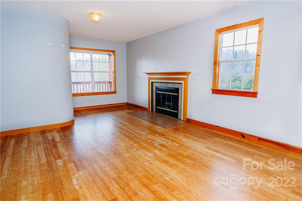300 Boyd Road Leicester, NC 28748 - Photo 7 of 46 a view of empty room with wooden floor and fan