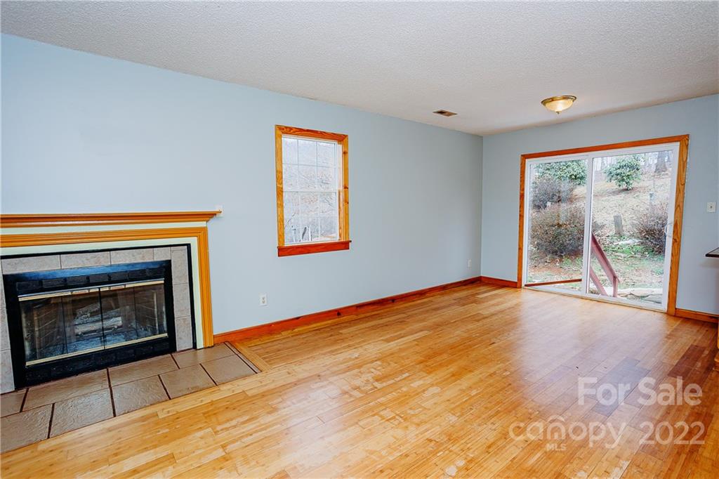 300 Boyd Road Leicester, NC 28748 - Photo 9 of 46 a view of an empty room with a fireplace and a window