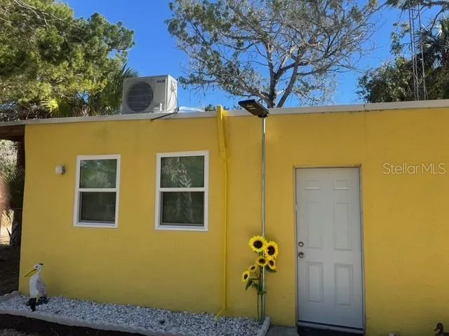 a view of a house with a tree