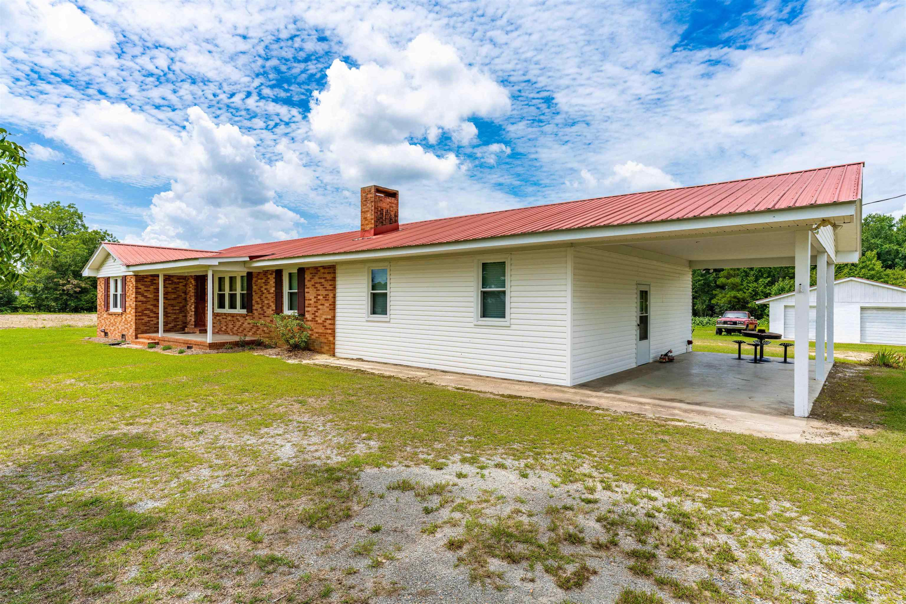 420 Faith Church Road Four Oaks, NC 27524 - Photo 2 of 36 a view of outdoor kitchen and entertaining space