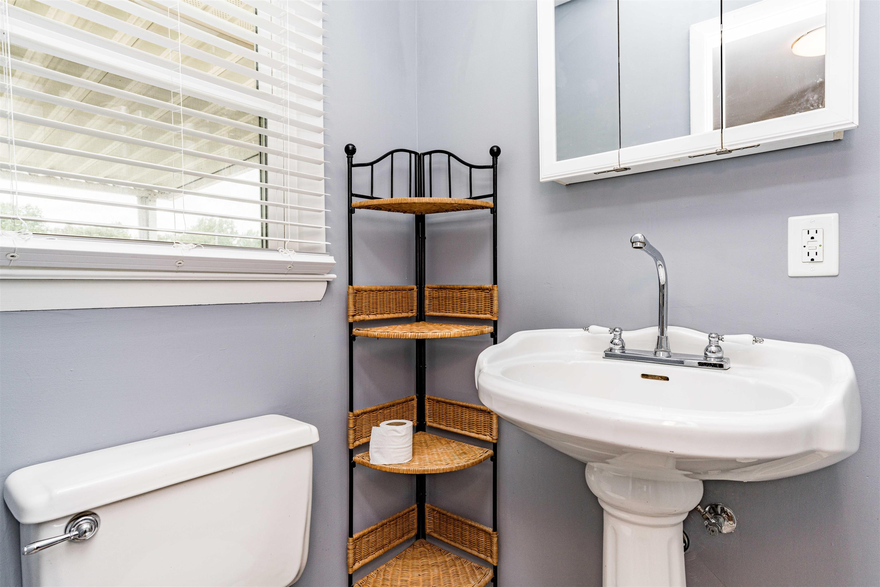 420 Faith Church Road Four Oaks, NC 27524 - Photo 23 of 36 a bathroom with a sink a toilet and mirror