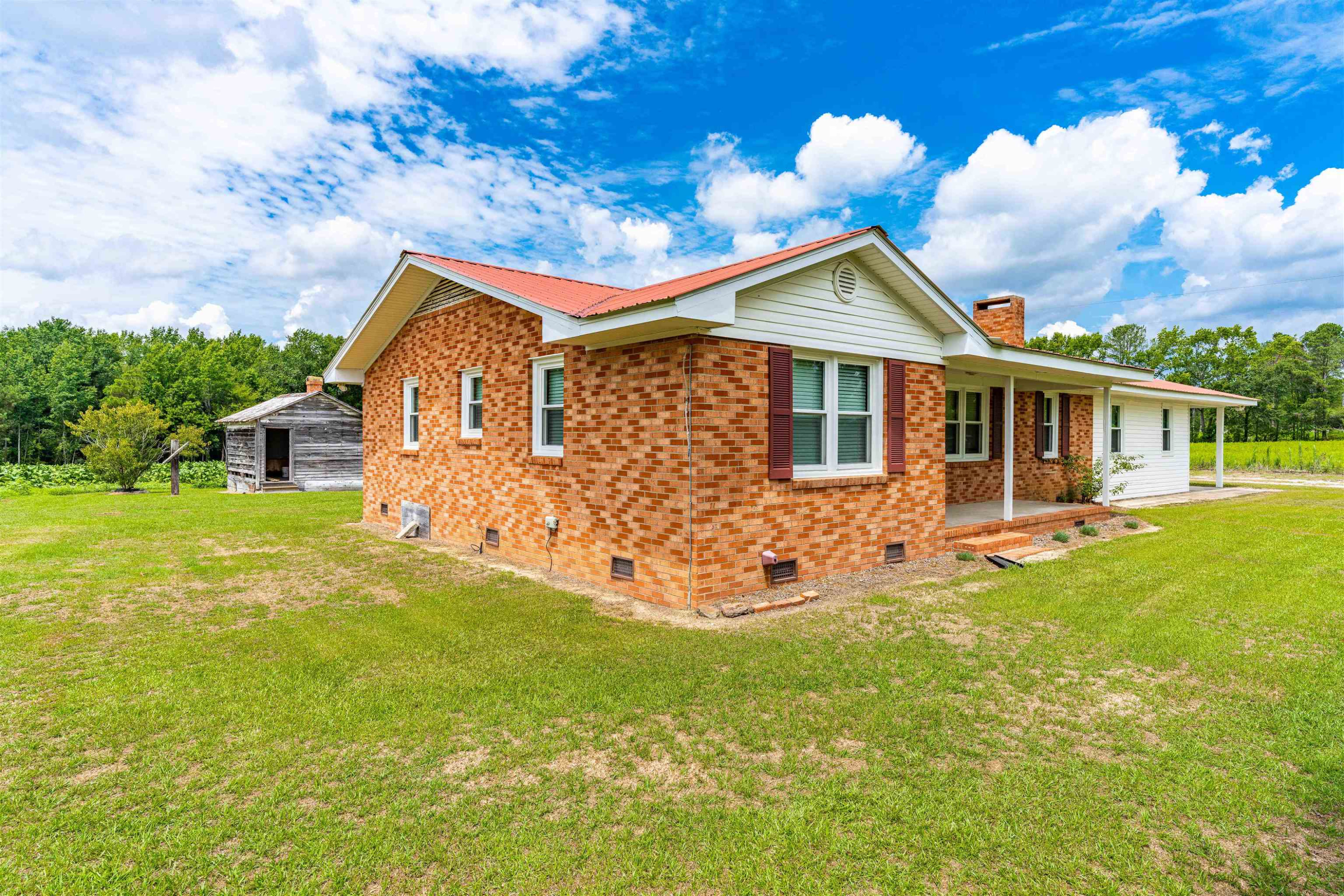 420 Faith Church Road Four Oaks, NC 27524 - Photo 3 of 36 a front view of a house with garden