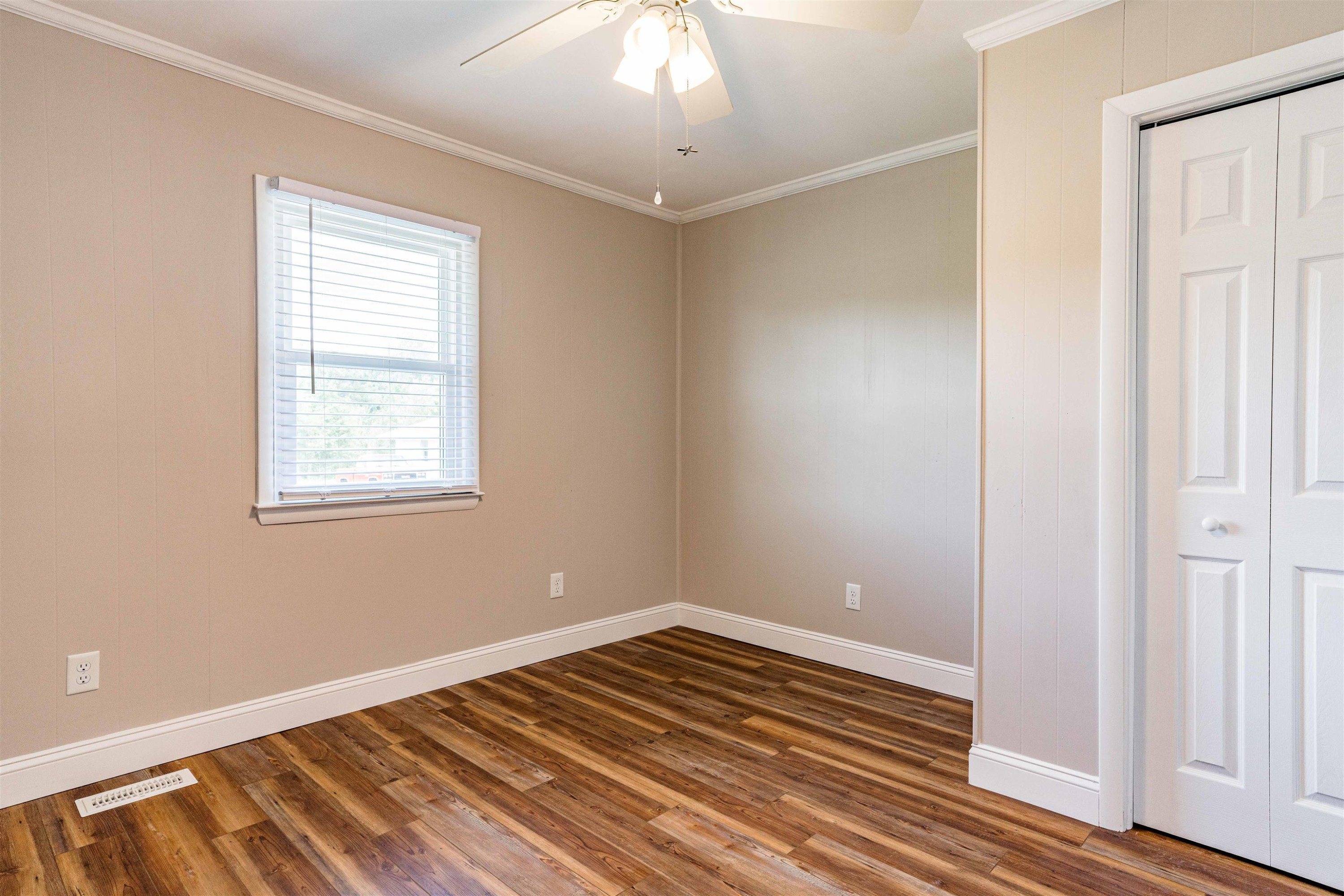 420 Faith Church Road Four Oaks, NC 27524 - Photo 31 of 36 a view of a room with wooden floor and chandelier fan