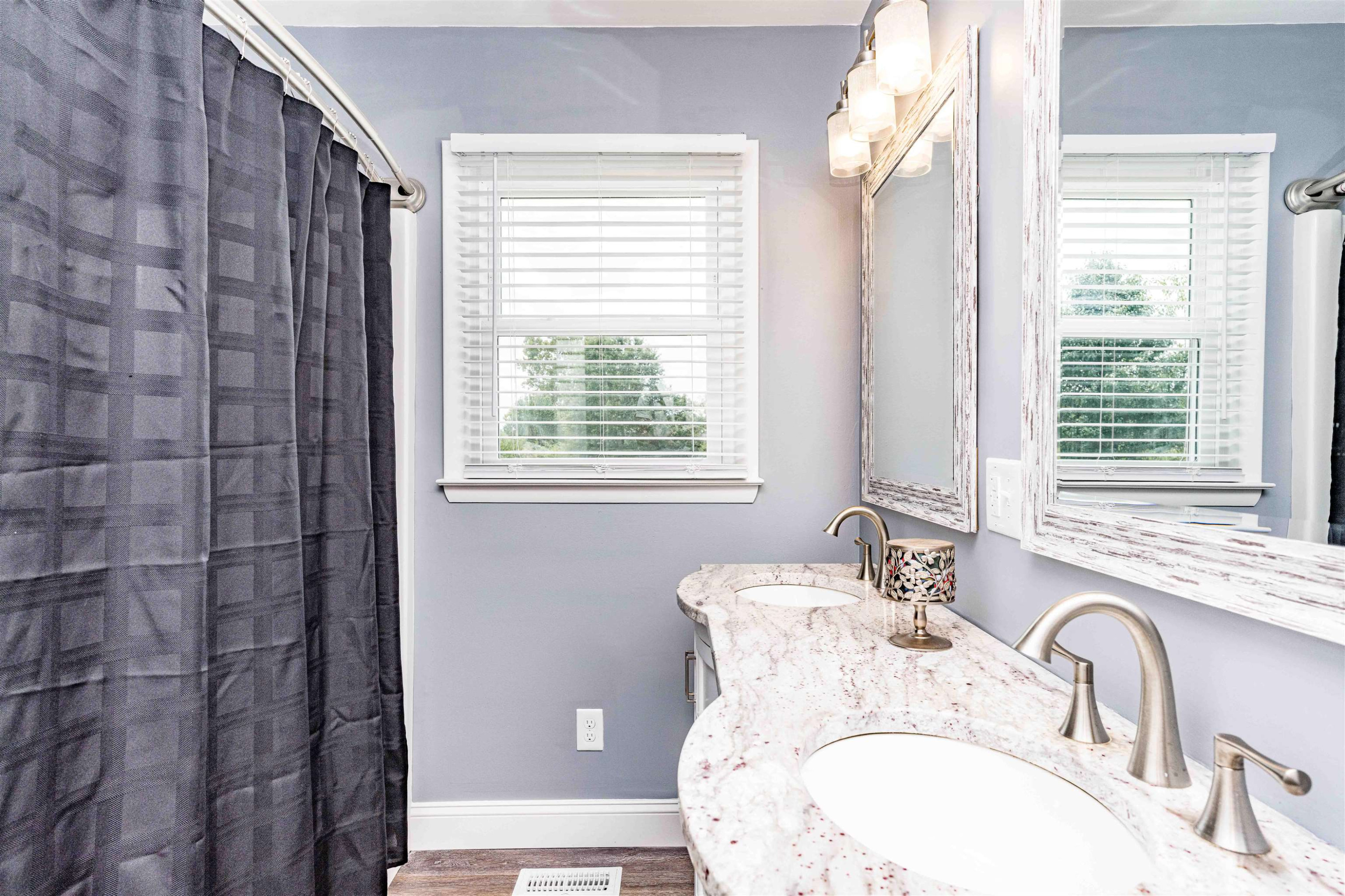 420 Faith Church Road Four Oaks, NC 27524 - Photo 34 of 36 a bathroom with a granite countertop sink a mirror and a shower