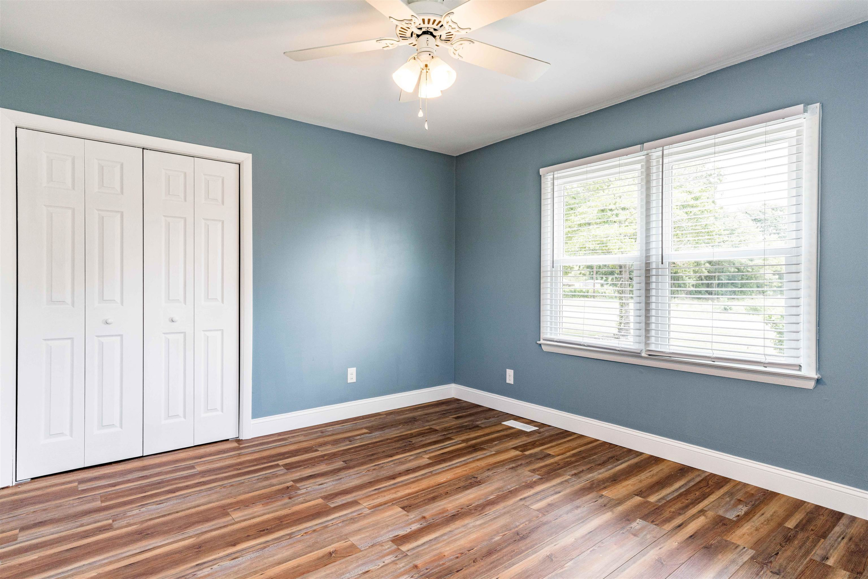420 Faith Church Road Four Oaks, NC 27524 - Photo 35 of 36 a view of an empty room with wooden floor and a window